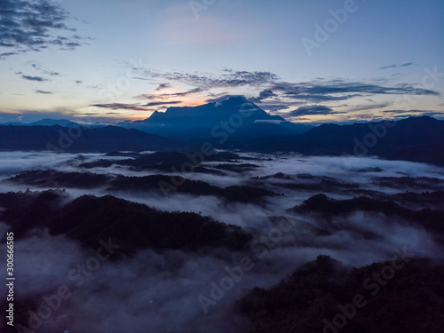 Rural landscape with dramatic sea of cloud during sunrise with Mount Kinabalu at Saba, Borneo © alenthien