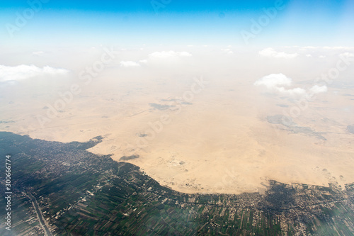 Border between sand desert and green zone of Helwan city. The Pyramid of Djoser can be seen.