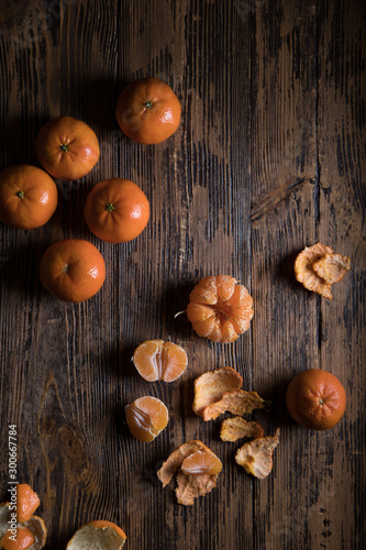 Orange or mandarin on wooden dark background. Winter mood.