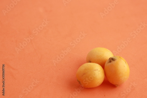 delicious yellow medlar fruit with colorful background photo