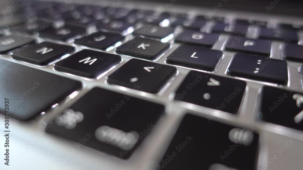 4K video close up shot of used laptop computer or notebook keyboard keys. Close up on letters