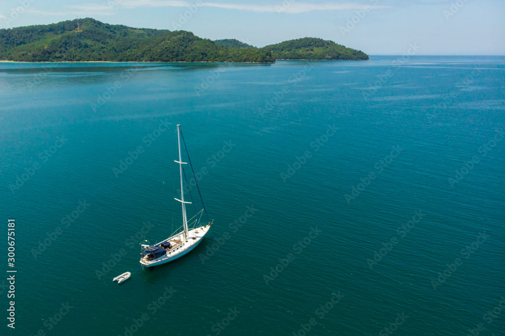 Aerial view of white Yacht in deep blue sea with beautiful landscape view in Kuala Abai, Kota Belud, Sabah, Malaysia Aerial view of white Yacht in deep blue sea with beautiful landscape view in Kuala Abai, Kota Belud, Sabah, Malaysia