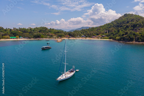 Aerial view of white Yacht in deep blue sea with beautiful landscape view in Kuala Abai, Kota Belud, Sabah, Malaysia