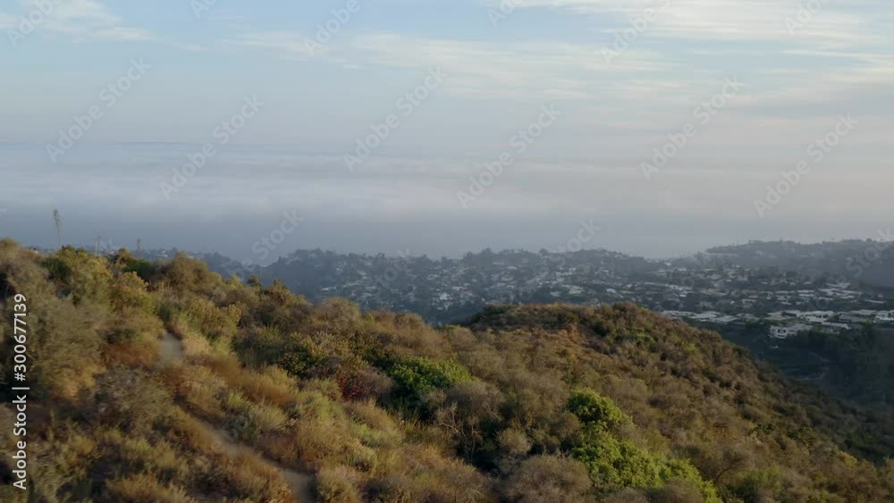 Aerial, descending, drone shot, towards hills, at golden hour, on a sunny evening, in Los Angeles, California, USA Aerial, descending, drone shot, towards hills, at golden hour, on a sunny evening, in Los Angeles, California, USA