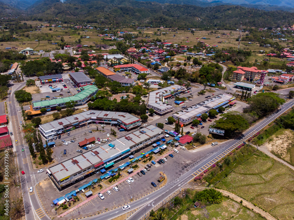 Aerial drone image of Small town with beautiful rural landscape surrounding of paddy field at Tambuanan Town, Sabah, Malaysia 