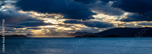 loch linnhe at sunset showing the ardnamurchan peninsula with golden and pink light on the clouds in october in the argyll region of the highlands of scotland photo