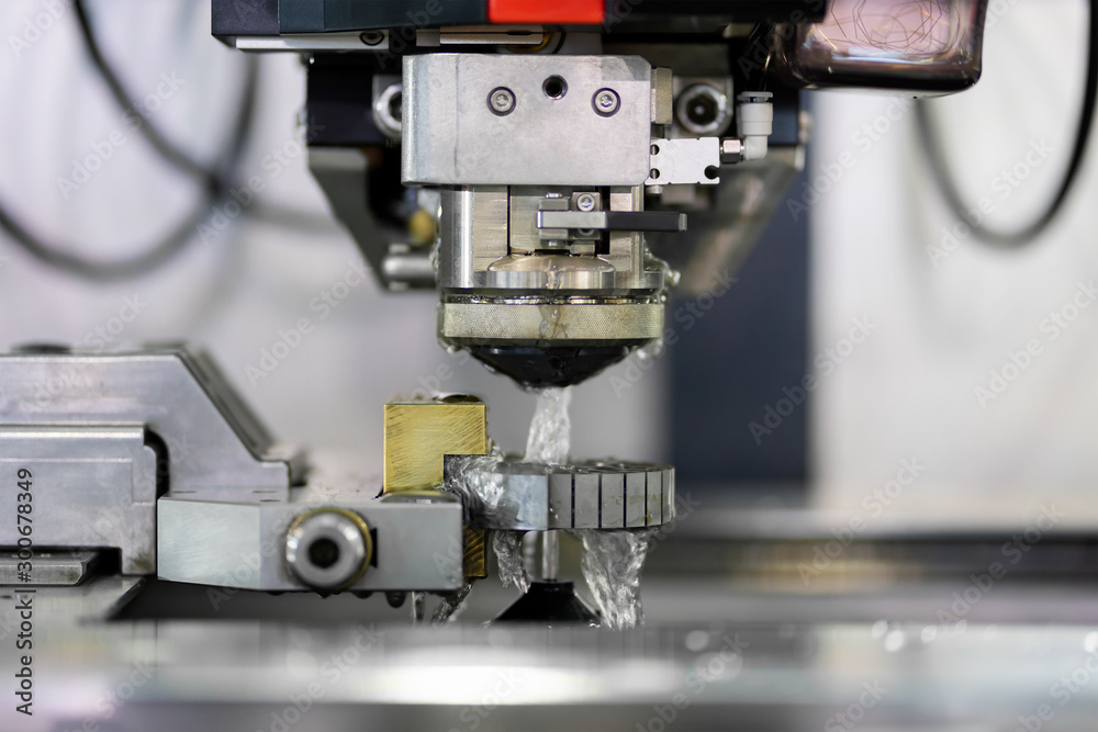 High precision CNC wire cut machine working, operator machining die metal mold process in the factory High precision CNC wire cut machine working, operator machining die metal mold process in the factory