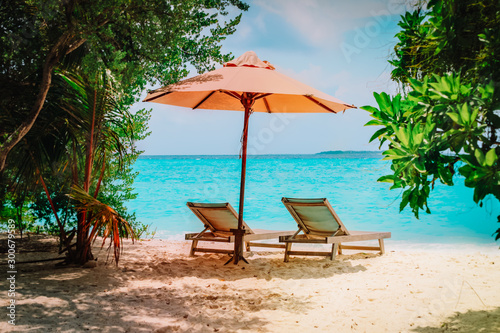 Two beach chairs on tropical sea vacation