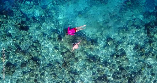 two tourists Snorkeling In Gorgeous Tropical Water and healthy coral reef