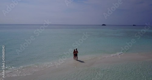 summer love, date on the tropical sandbank, Maldives, romantic couple flirting on the sandy beach photo