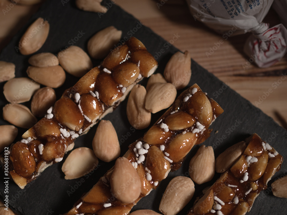 Fototapeta premium Turron bar of caramelised sugar and almonds. Traditional spanish Christmas sweets