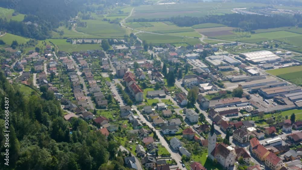Sliding right shoot of small village in Slovenia. Traditional village with church in the middle and small industry in town to keep people working in Slovenia. Sliding right shoot of small village in Slovenia. Traditional village with church in the middle and small industry in town to keep people working in Slovenia.