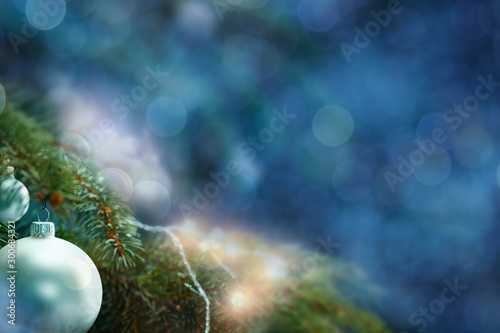 Christmas decorations in bright blue red gold  and white shiny and shimmering colors with Christmas lights with blurred background. 