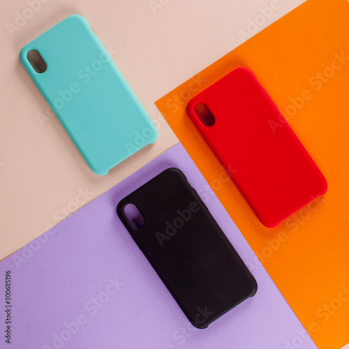 Cell phone cases various colors on multicolor paper background
