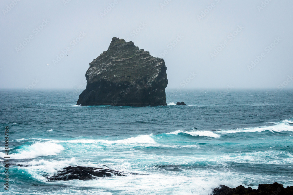 Fototapeta premium Big rock in the ocean just outside the icelandic coastline in the south. Popular, visit, place and travel concept.