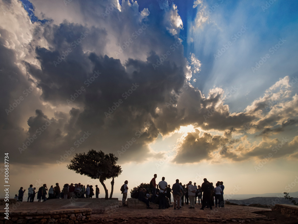 Christian pilgrims on the Mount of Exile (Mount Leap) of Jesus of Nazareth at sunset.