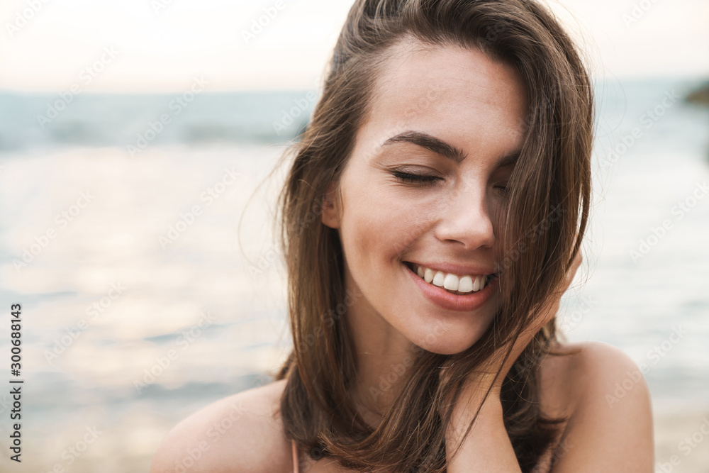 Image of happy caucasian woman smiling with eyes closed Image of happy caucasian woman smiling with eyes closed
