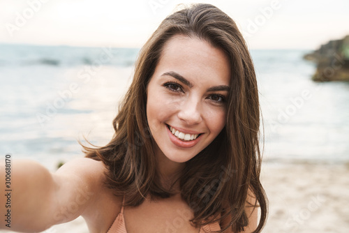 Image of joyful caucasian woman smiling and taking selfie photo © Drobot Dean