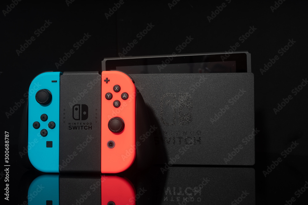 Nintendo Switch video game console developed by Nintendo, released on March  3, 2017 on a black background. Germany, Berlin - June 30, 2019: Nintendo  Switch Joy-con controller on a white background foto