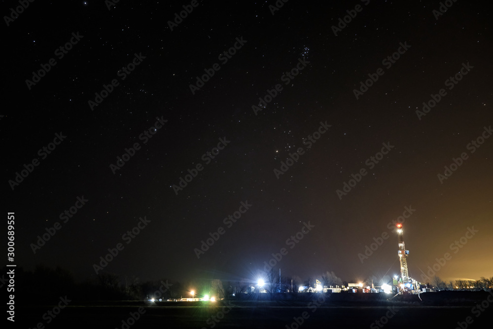 Fototapeta premium The rig was used to explore the gas and oil field at night against the starry sky. drilling rig and the starry sky