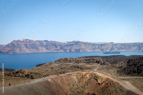 View from Nea kameni in Greece over the island of Oia and Thira. Tourists and cruiseship. photo