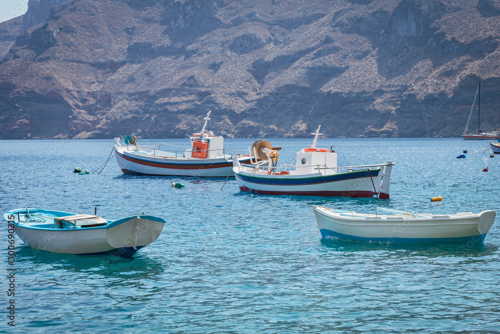 Fishing boats in Santorini, Greece. Fishing, summer, boats, travel, transport, holiday concept.