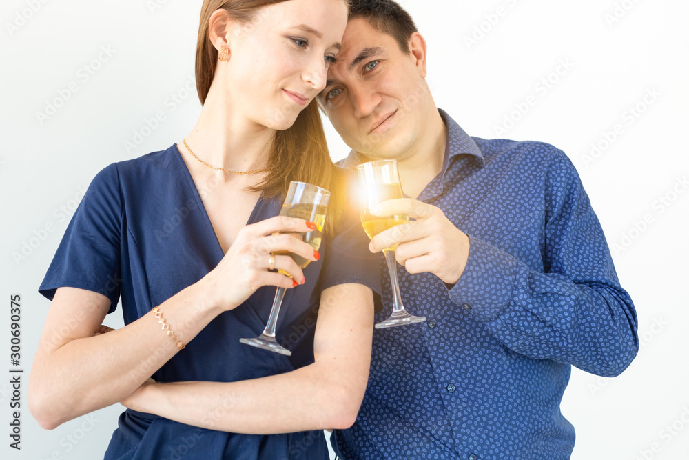 Close-up of man and woman celebrating Christmas or New Year eve party with glasses of champagne. Close-up of man and woman celebrating Christmas or New Year eve party with glasses of champagne.