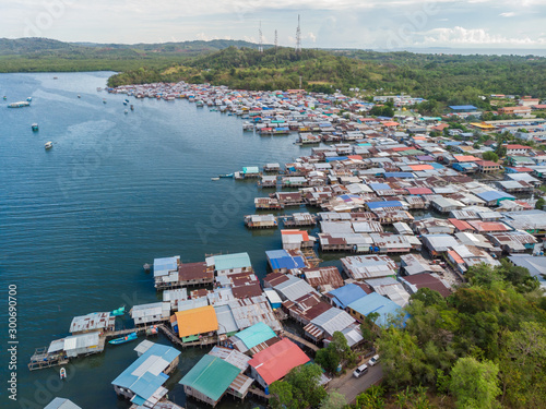 Top down aerial view of the local lifestyle traditional water village houses in a small village Beside sea at Kudat, Sabah, Borneo.  photo