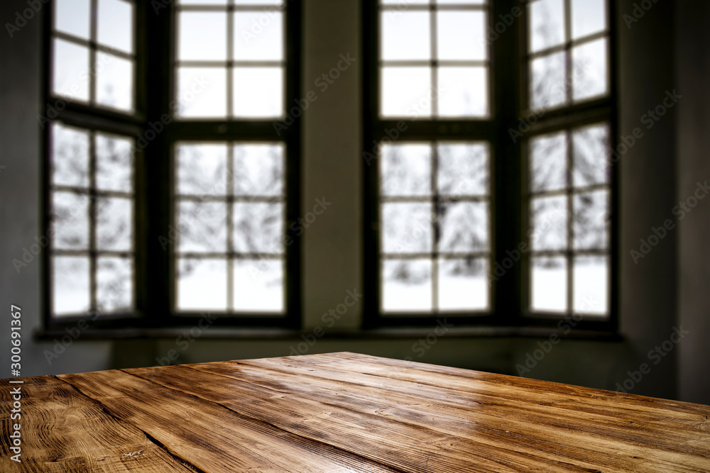 Table top with big window background and beautiful snowy winter landscape outside. Sunny winter day. Table top with big window background and beautiful snowy winter landscape outside. Sunny winter day.