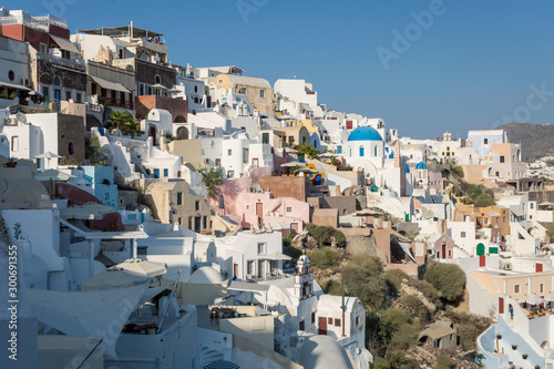 View over the buildings in the cliffside of Oia, Santorini. Architecture, buildings, houses, culture, travel, europe concept.