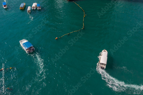 Aerial image of tourist speed boat on moving at clear blue sea at Waterfront Kota Kinabalu, Sabah, Malaysia © alenthien