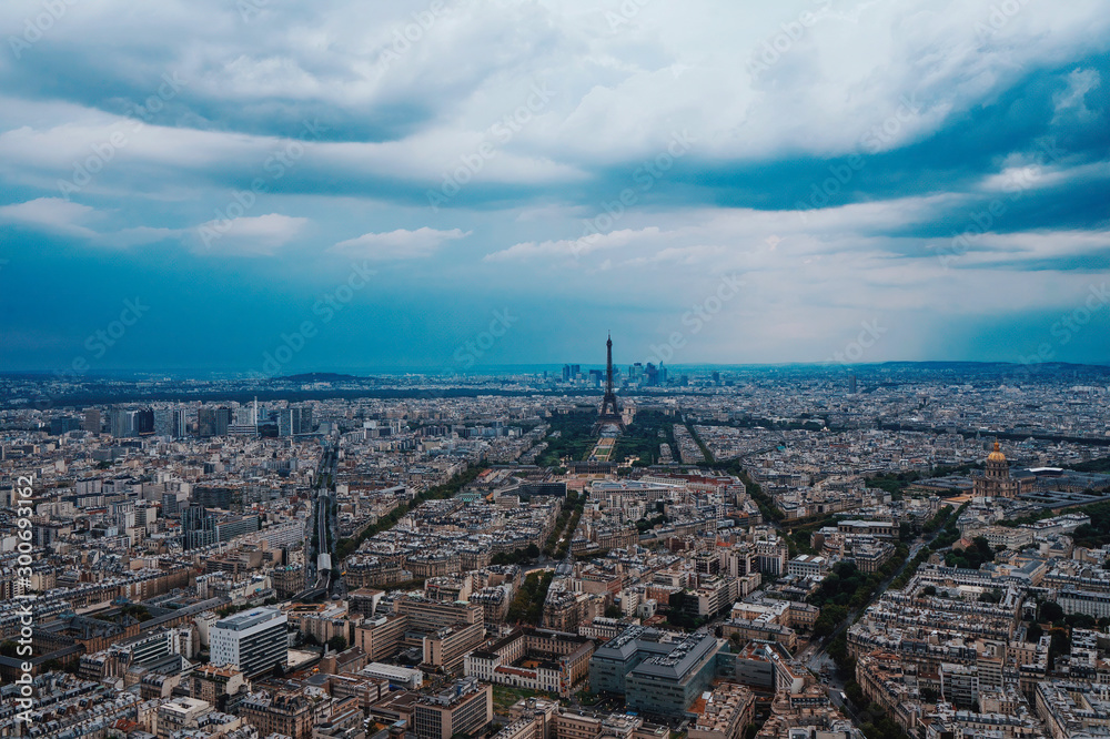 Eiffel tower encounters a heavy summer storm with Paris city view