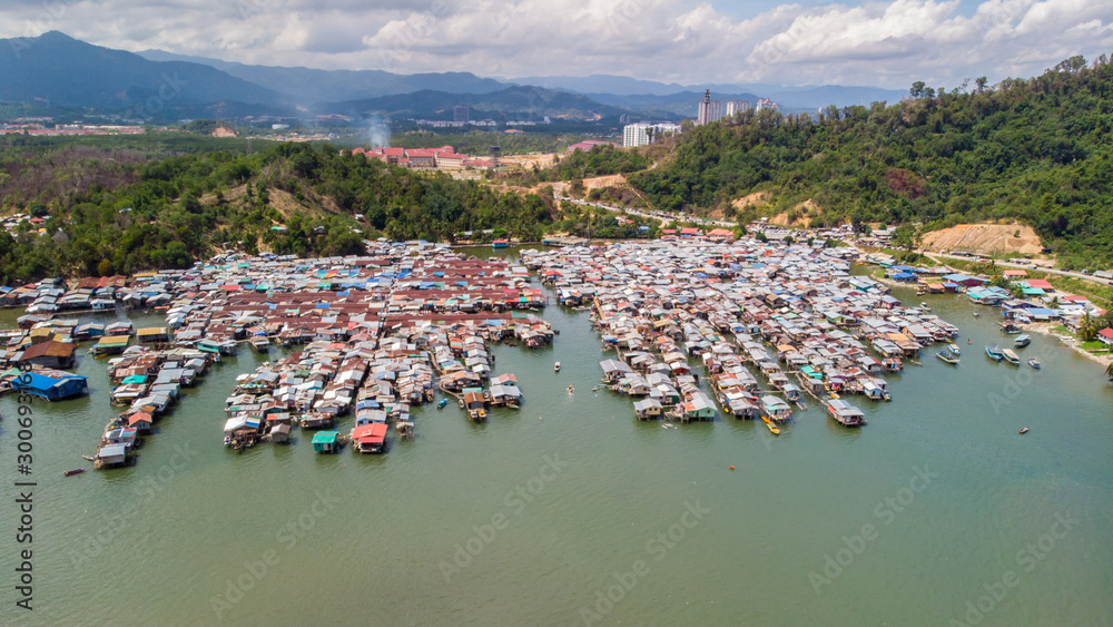 Top down aerial view of the water village houses in a small village Beside river at Sabah, Borneo