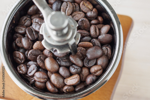 Vintage manual coffee grinder with roasted coffee beans