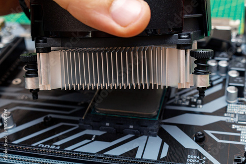 Installing a cooler on a personal computer processor. The process of upgrading computer maintenance in a service.