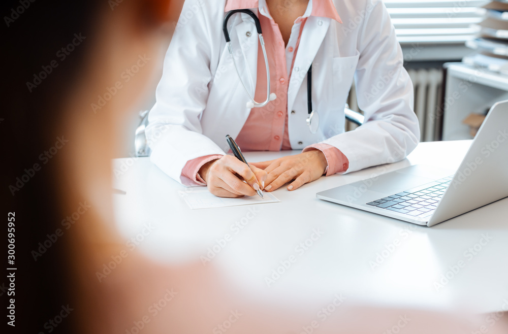 Close-up of doctor taking notes while having appointment with patient - obrazy, fototapety, plakaty 