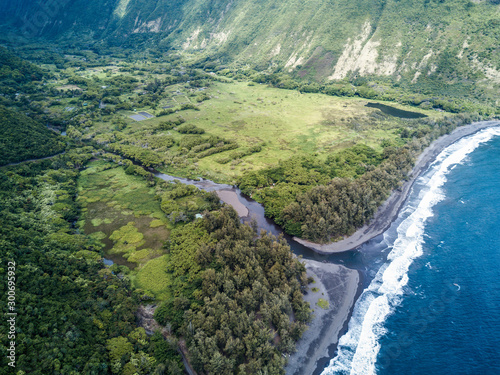 Aerial drone shot view of bridge over a river flows into pacific ocean on big island in Hawaii