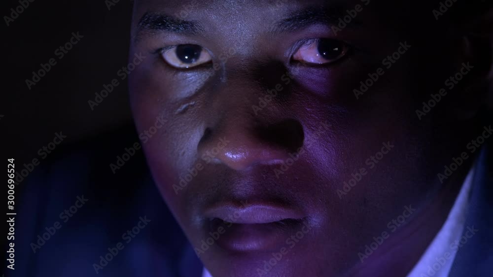 Pensive young american african business man alone in the dark Pensive young american african business man alone in the dark