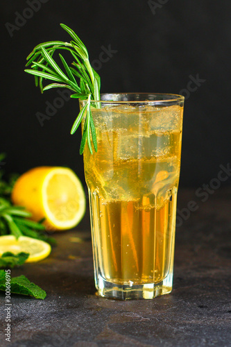 lemonade ice in a glass with rosemary (tasty drink, beverage) menu concept. food background. top view. copy space