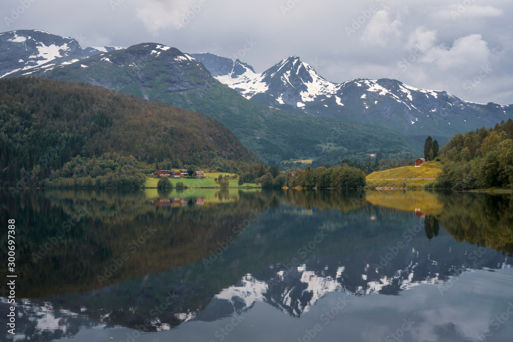 Beautiful mountain scenery and reflections in Lake in the western part of Norway. Road trip, holiday, scenery, landscape concept.