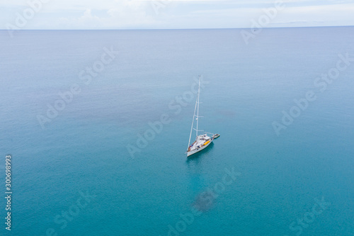 Aerial view of white Yacht in deep blue sea with beautiful landscape view in Kudat  Sabah  Borneo