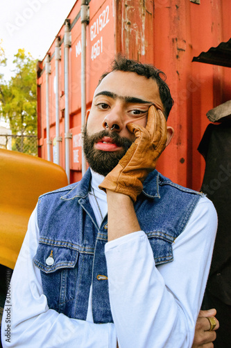 Close up of man with gloved hand on face