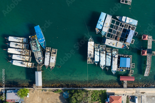 Aerial image of local lifestyle fisherman boat parking at fresh seafood market jetty at Kudat, Sabah, Malaysia. © alenthien