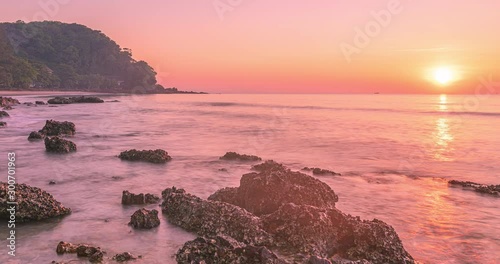 Sunrise seascape with beautiful golden light at a tropical beach in Rayong, Thailand.