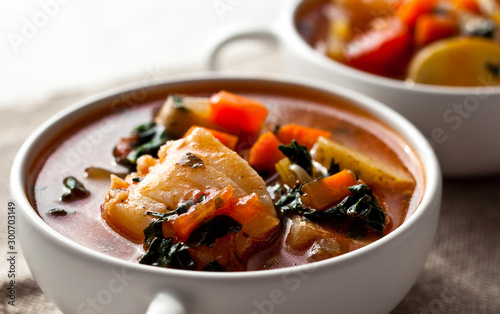 Mediterranean fish chowder with potatoes and black kale photo