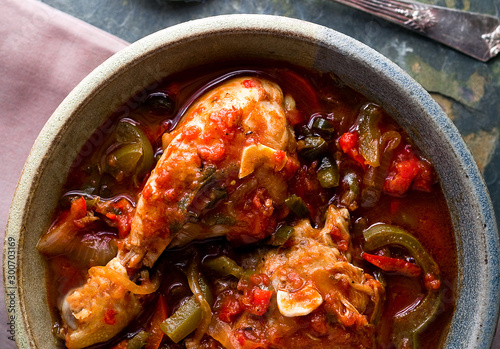 Overhead view of chicken and pepper stew in bowl photo