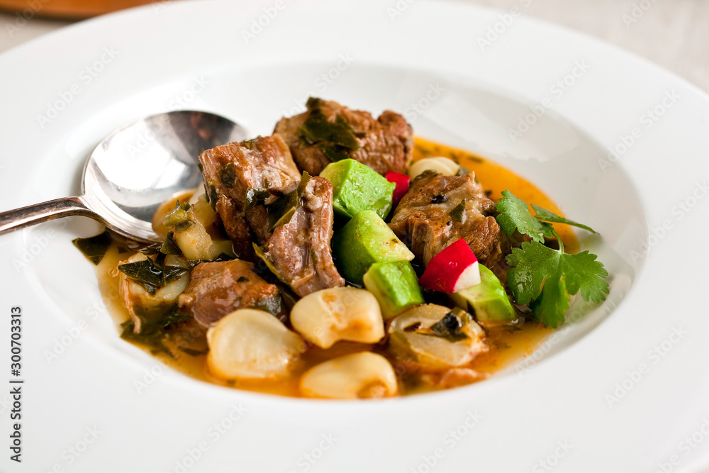Spicy pork and hominy stew with collard greens Spicy pork and hominy stew with collard greens