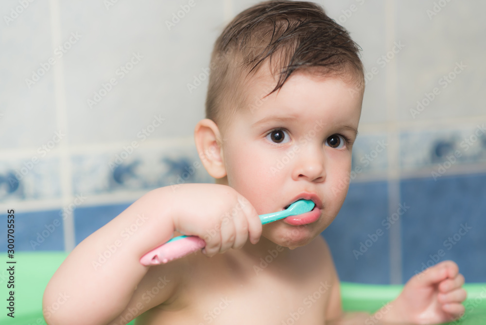 lovely baby brushing his teeth with a toothbrush in the bathroom lovely baby brushing his teeth with a toothbrush in the bathroom