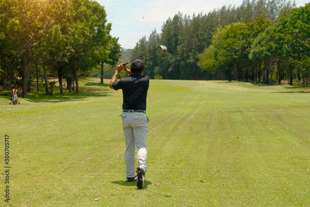 Golfer playing golf in beautiful golf course in the evening golf course with sunshine in thailand Golfer playing golf in beautiful golf course in the evening golf course with sunshine in thailand