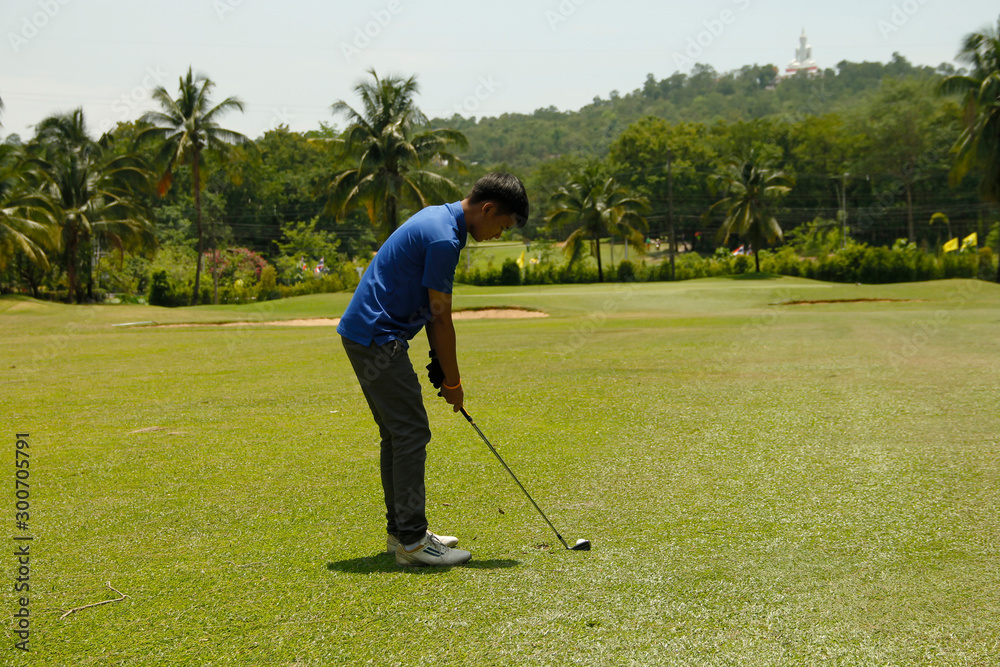 Fototapeta premium Golfer playing golf in beautiful golf course in the evening golf course with sunshine in thailand